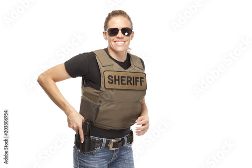 Happy policewoman wearing sunglasses photo