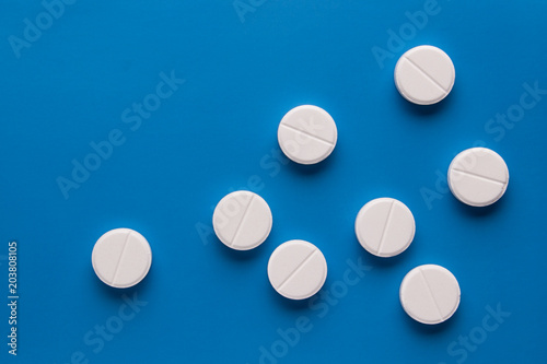 white pills on a blue background  medicine