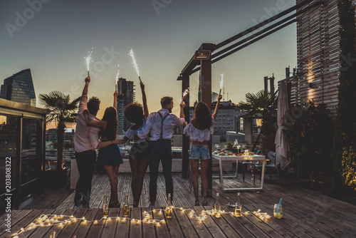 Friends partying on a rooftop photo
