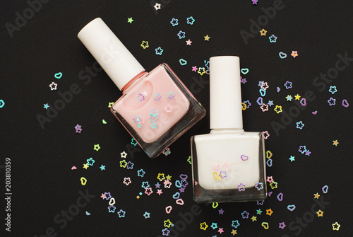 Set Nail Polishes Bottles Siny Sparkle Decoration Isoalted on Black photo