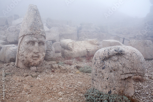 Ancient statues of Heracles and Persian Eagle God on the top of Nemrut mount, Turkey photo