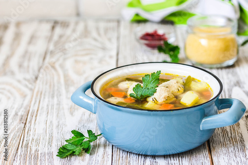 Instant pot turkey meatball soup in a pot on white rustic background. Selective focus, space for text. photo