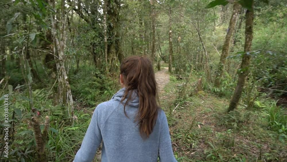 Woman walking in tropical forest Woman walking in tropical forest