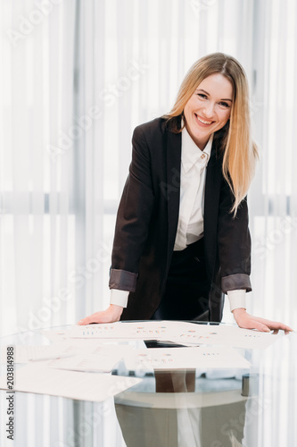 business lady at work. company manager. woman smiling into camera standing in office. professional corporate dresscode © golubovy