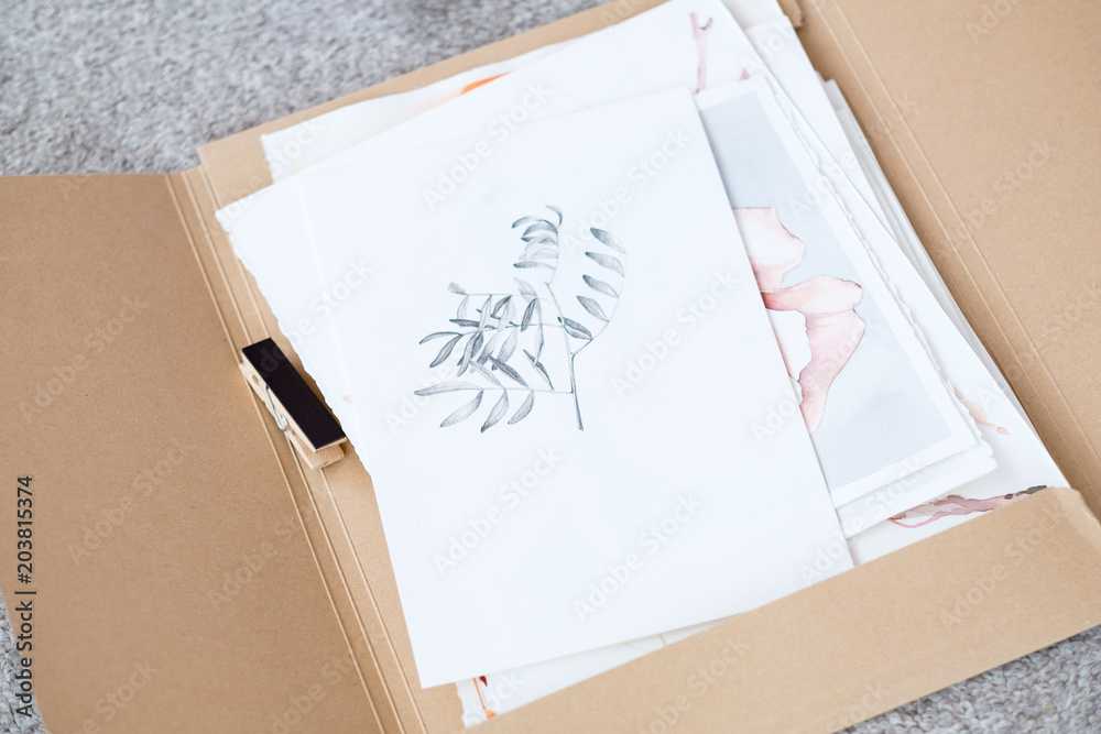 Fototapeta premium art painting inspiration creativity nature concept. picture of a herb. drawing of a twig with leaves. artist creations. folder full of paintings on paper