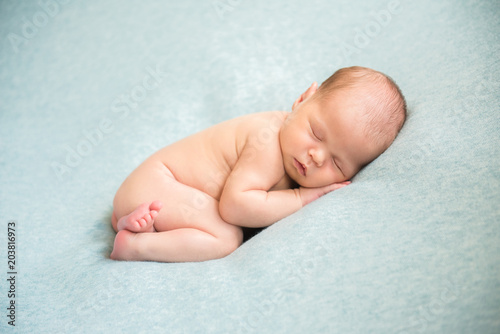 Newborn baby sleeping peacefully naked