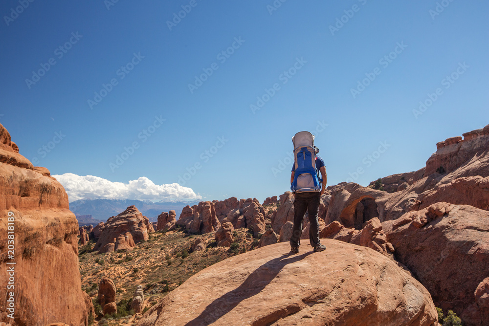 A family with baby son visits Arches National Park in Utah, USA