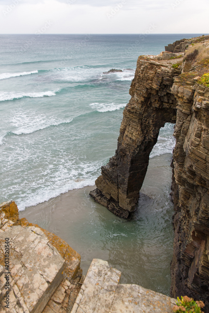 View from above of one of the rocky arches on the coast of Playa de las Catedrales in Lugo Spain 