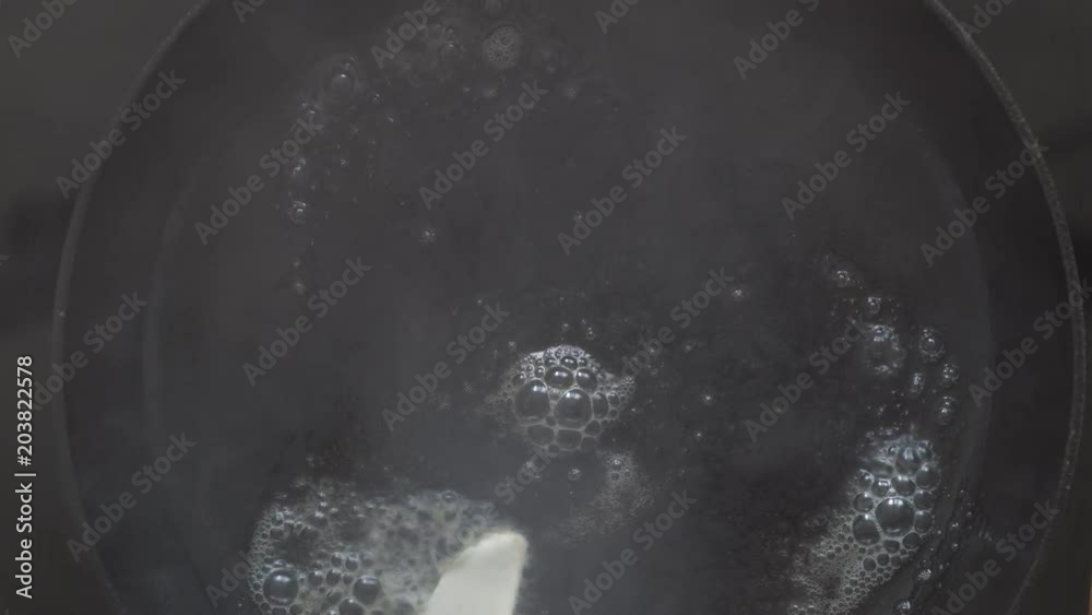 The castiron frying pan, butter and egg. Cooking eggs in hot butter. Unhealthy food with