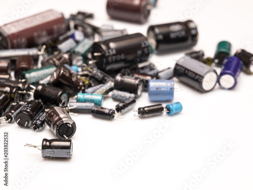 Old electrolitics capacitors isolated in white background selective focus. Recycling concept photo