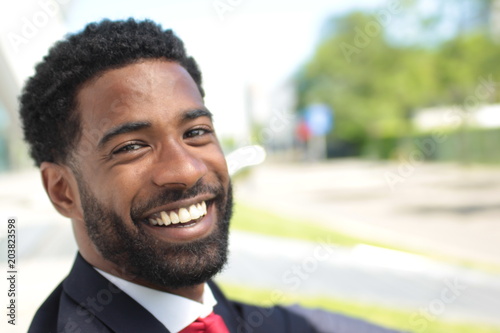 Beautiful happy businessman outside