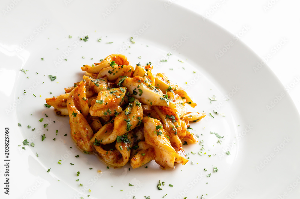 seafood marinated in orange juice, vinegar, and garlic fried in olive oil and decorated with cilantro seafood marinated in orange juice, vinegar, and garlic fried in olive oil and decorated with cilantro