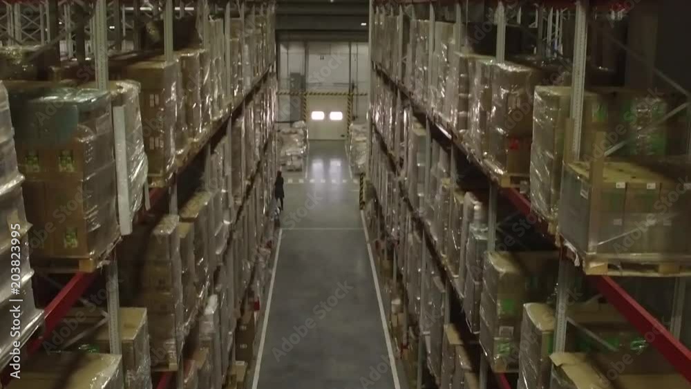 Shelves and racks in distribution warehouse interior.Rows with cardboard boxes and goods at shelves.Logistic, transportation and storage concept. Shelves and racks in distribution warehouse interior.Rows with cardboard boxes and goods at shelves.Logistic, transportation and storage concept.