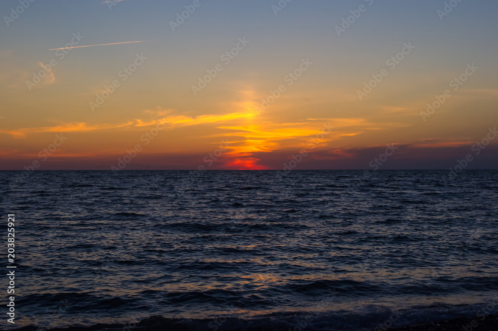 Amazing sea sunset, the sun, waves, clouds