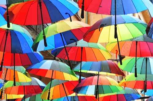 Decorative hanging umbrellas in the colors of the rainbow.