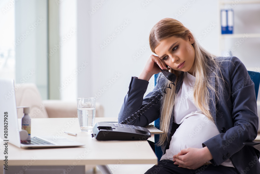 Pregnant woman employee in the office Pregnant woman employee in the office