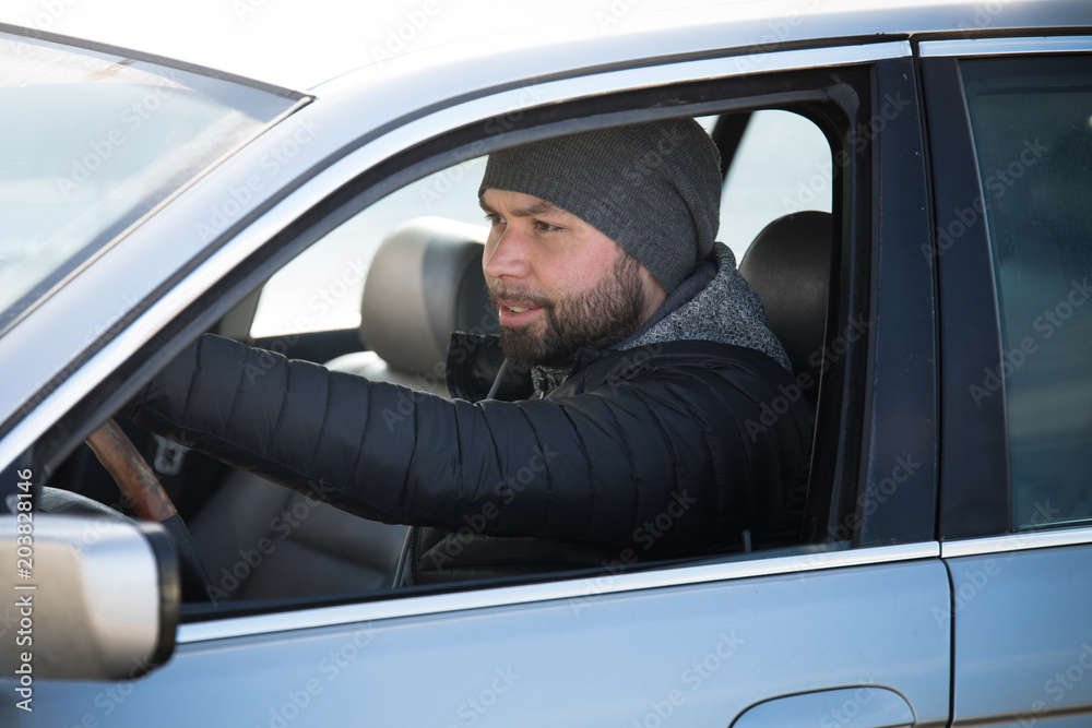 Portrait of man in his car. Portrait of man in his car.
