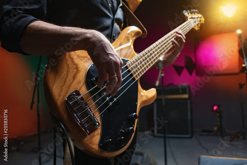 bass guitar in the hands of a musician photo