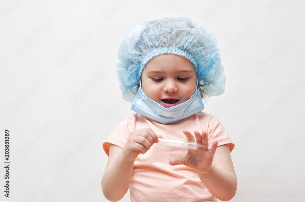 Adorable little girl playing at the doctor