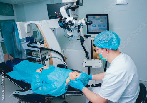 Eye surgery. A patient and surgeon in the operating room during ophthalmic surgery. Vision correction