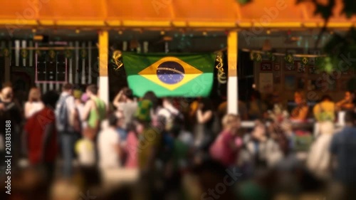 Brazil football fan party at outdoor bar (defocus)