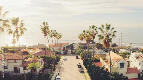 Aerial view of California beach city and palm trees at sunset