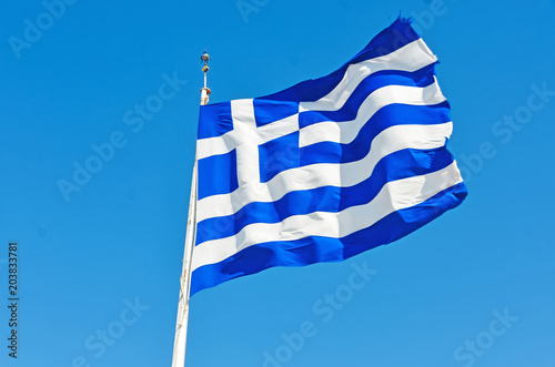 Greece flag in windy weather with blue sky