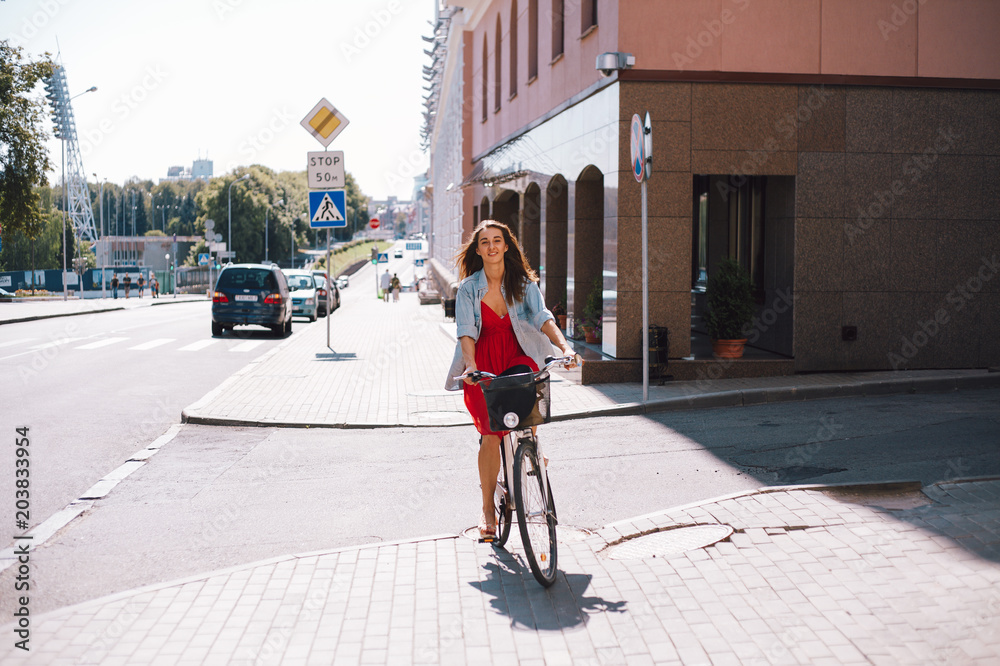 Fototapeta premium Girl riding bike street. Adventure vacation. Adventure holiday. Beautiful girl. Caucasian people outdoors.
