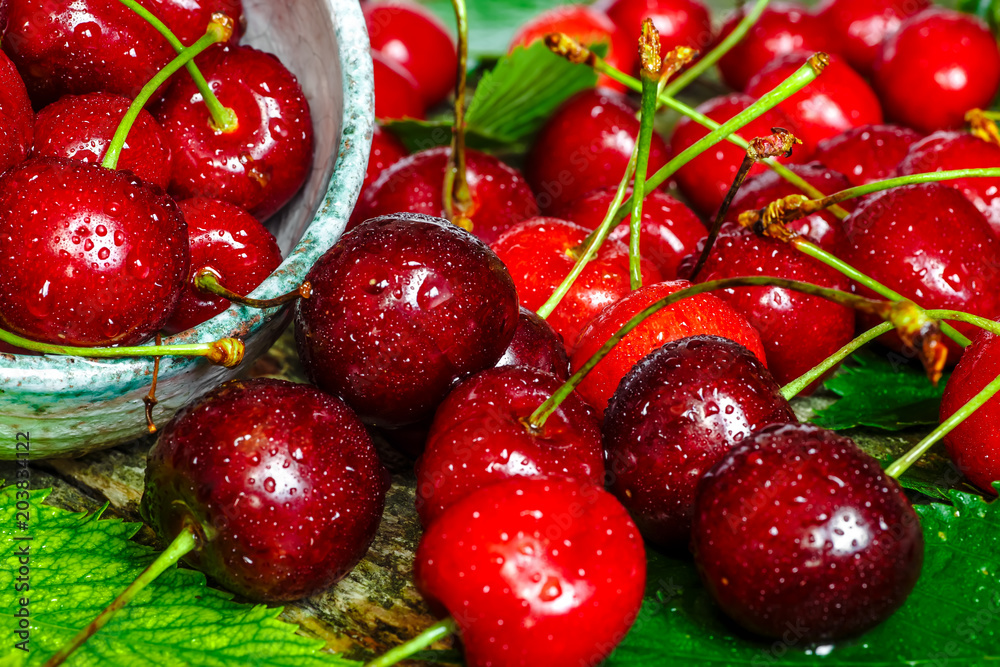 Cherries on wooden table with water drops macro background Cherries on wooden table with water drops macro background
