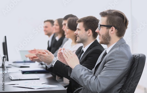 cheering business team sitting at Desk