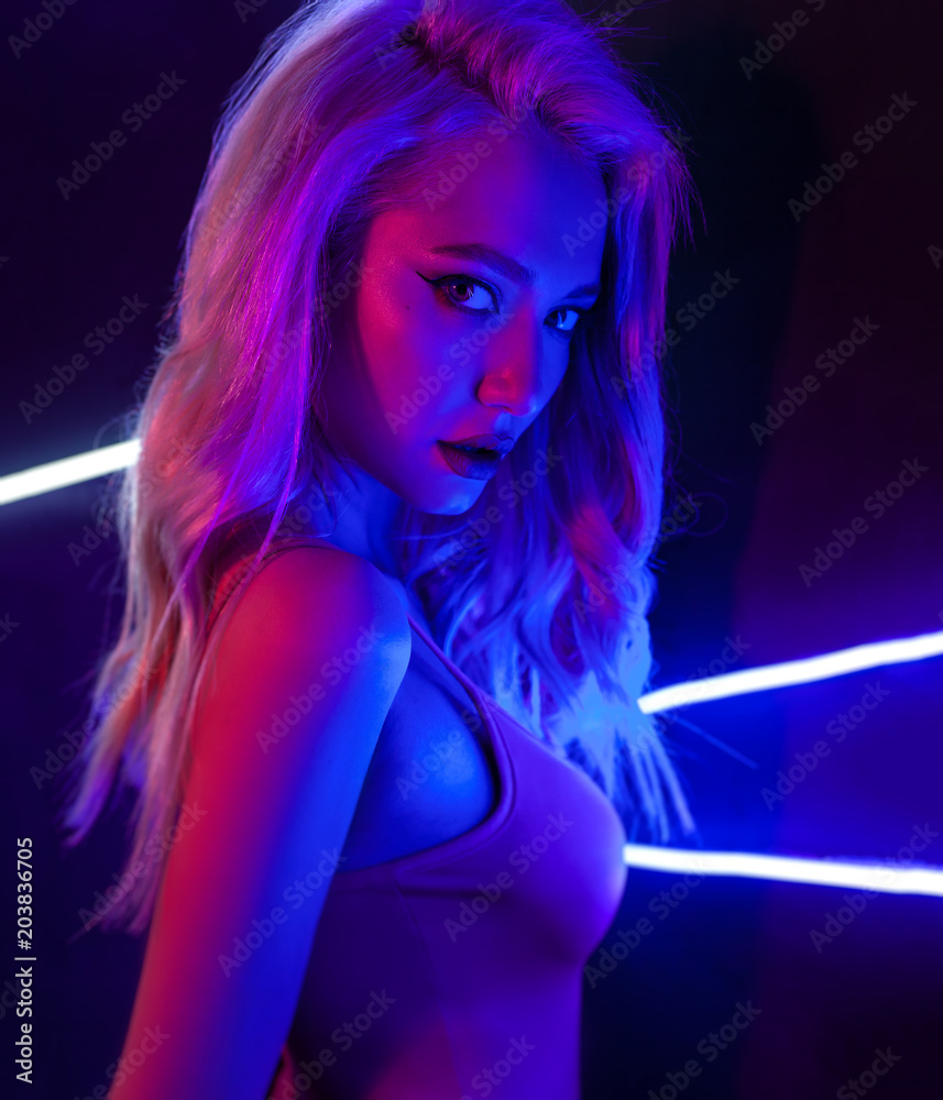 fashion art photo of sexy girl dressed in black in the night-club. Perfect  female body with neon lettering on the background Stock Photo | Adobe Stock