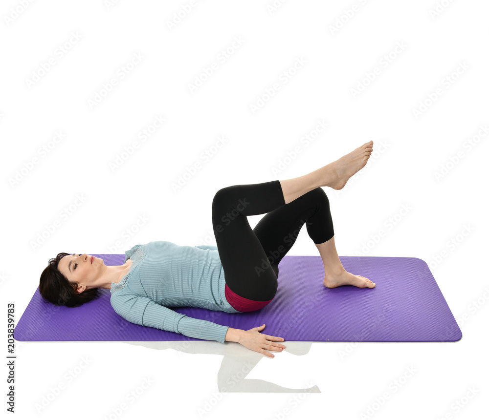 Mother woman exercising doing postnatal workout. Female fitness instructor stretching hands and legs in gym and work out exercises Mother woman exercising doing postnatal workout. Female fitness instructor stretching hands and legs in gym and work out exercises