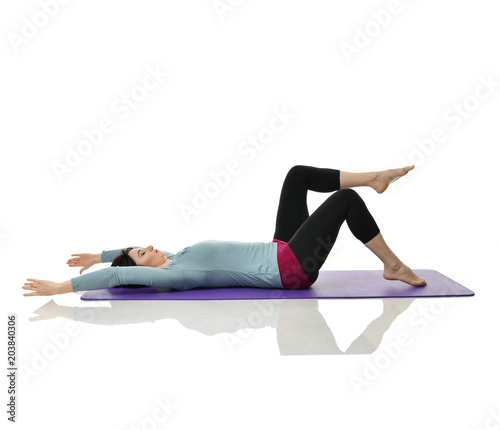 Fototapeta Naklejka Na Ścianę i Meble -  Mother woman exercising doing postnatal workout. Female fitness instructor stretching hands and legs in gym and work out exercises
