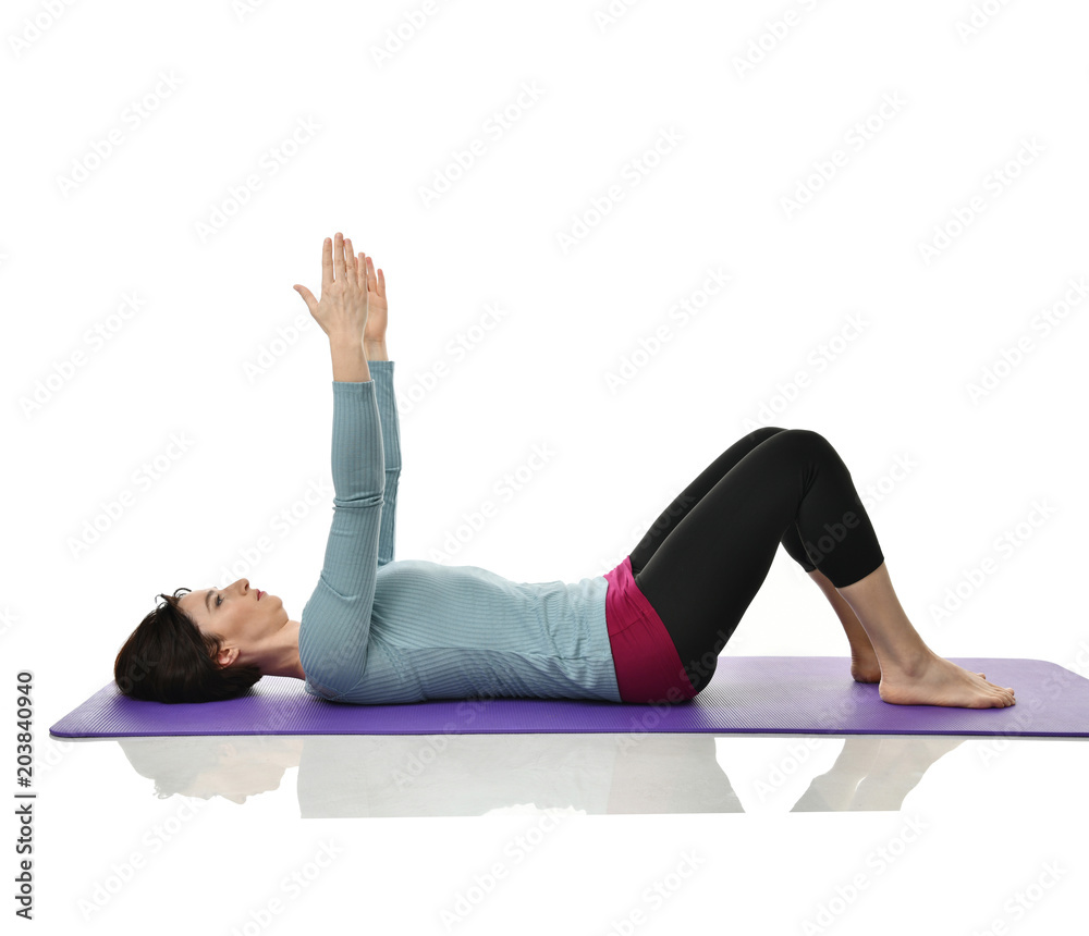 Mother woman exercising doing postnatal workout. Female fitness instructor stretching hands and legs in gym and work out exercises Mother woman exercising doing postnatal workout. Female fitness instructor stretching hands and legs in gym and work out exercises