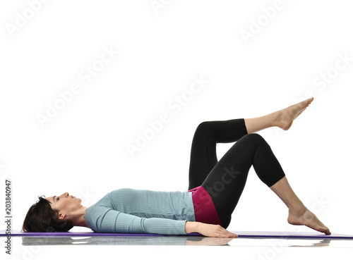 Fototapeta Naklejka Na Ścianę i Meble -  Mother woman exercising doing postnatal workout. Female fitness instructor stretching hands and legs in gym and work out exercises