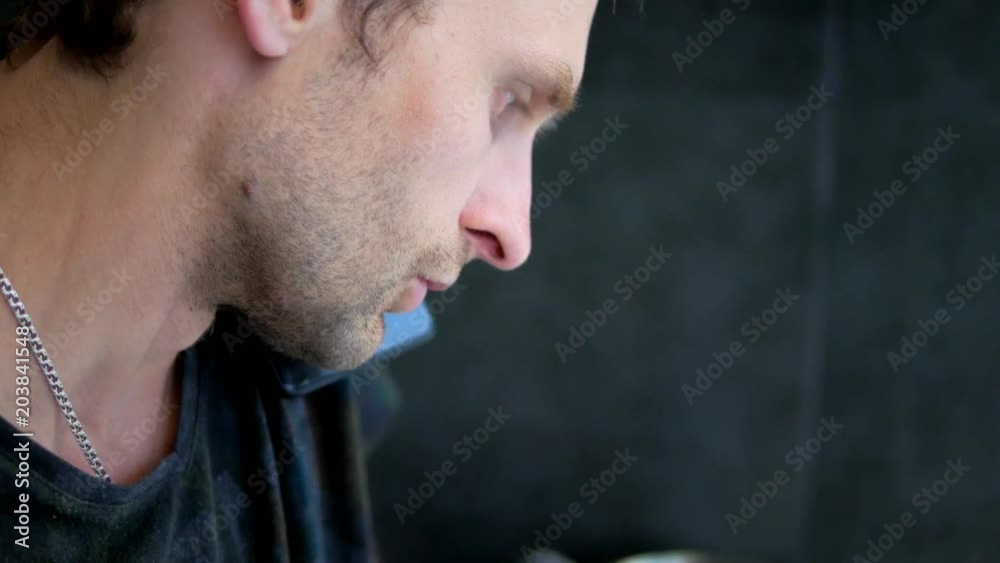 Adult man speaking with college by mobile from home and looking laptop close-up Adult man speaking with college by mobile from home and looking laptop close-up