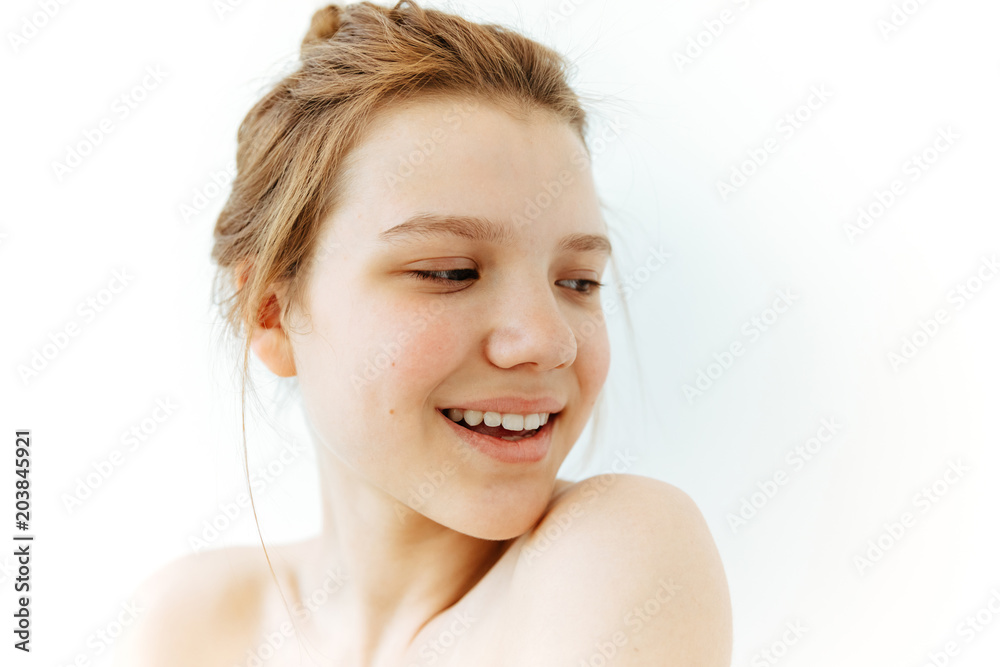 Cheerful Teen girl shoulders portrait on white background. Fresh and clean beauty face,smiling, youthfulness concept Cheerful Teen girl shoulders portrait on white background. Fresh and clean beauty face,smiling, youthfulness concept