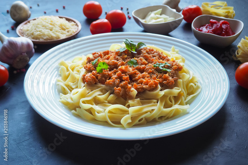 Pasta with bechamel sauce on a black background.