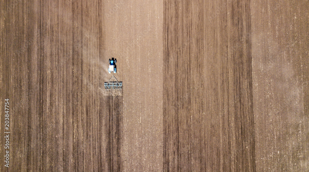 Farm machinery on the field. Agricultural landscape from the air Farm machinery on the field. Agricultural landscape from the air