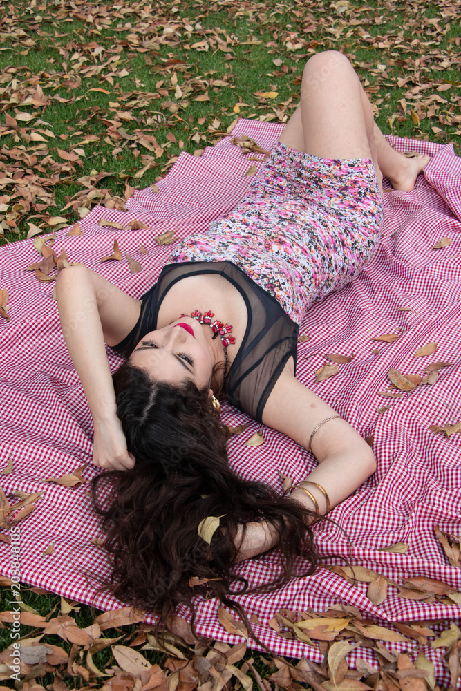 Naklejka premium Gorgeous young latina relaxing in the park