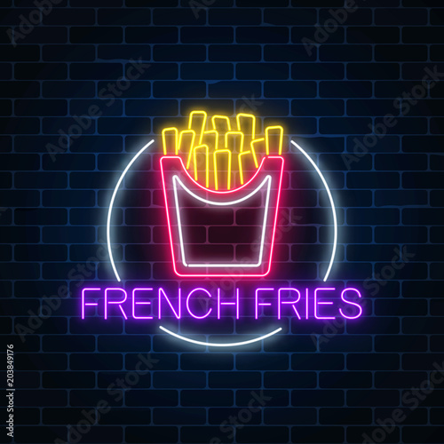 Neon glowing sign of burger in circle frame on a dark brick wall background. Fastfood light billboard symbol.
