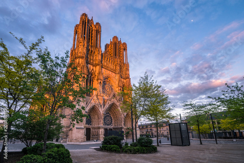 Warmly illuminated Reims cathedral in sunset light, France