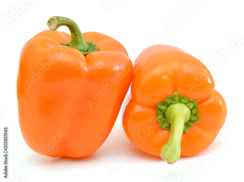 two fresh orange bell peppers on a white background