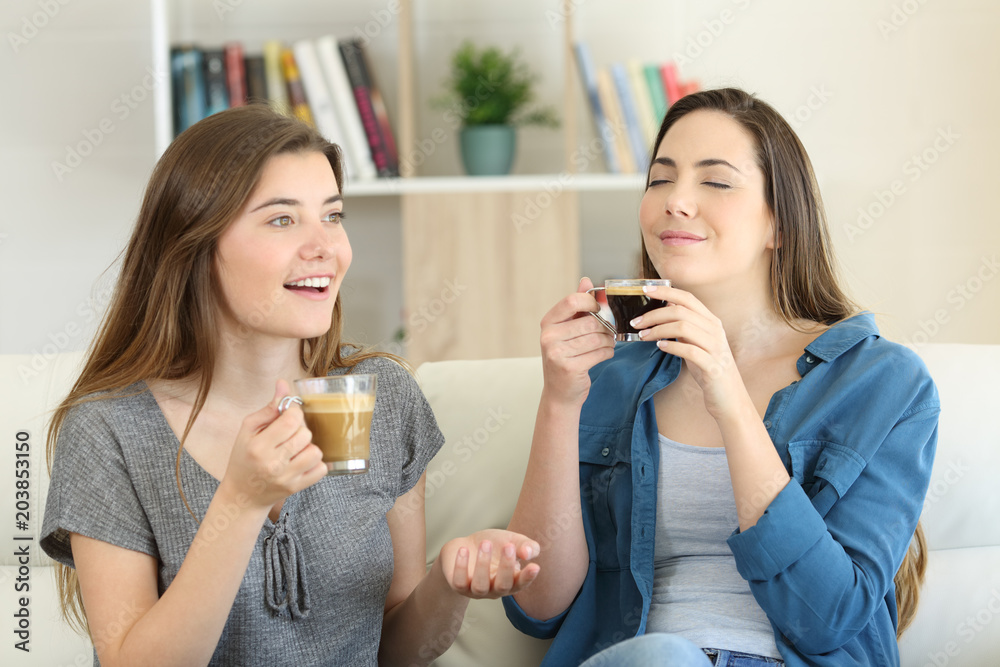 Two friends talking and enjoying a coffee cup Two friends talking and enjoying a coffee cup