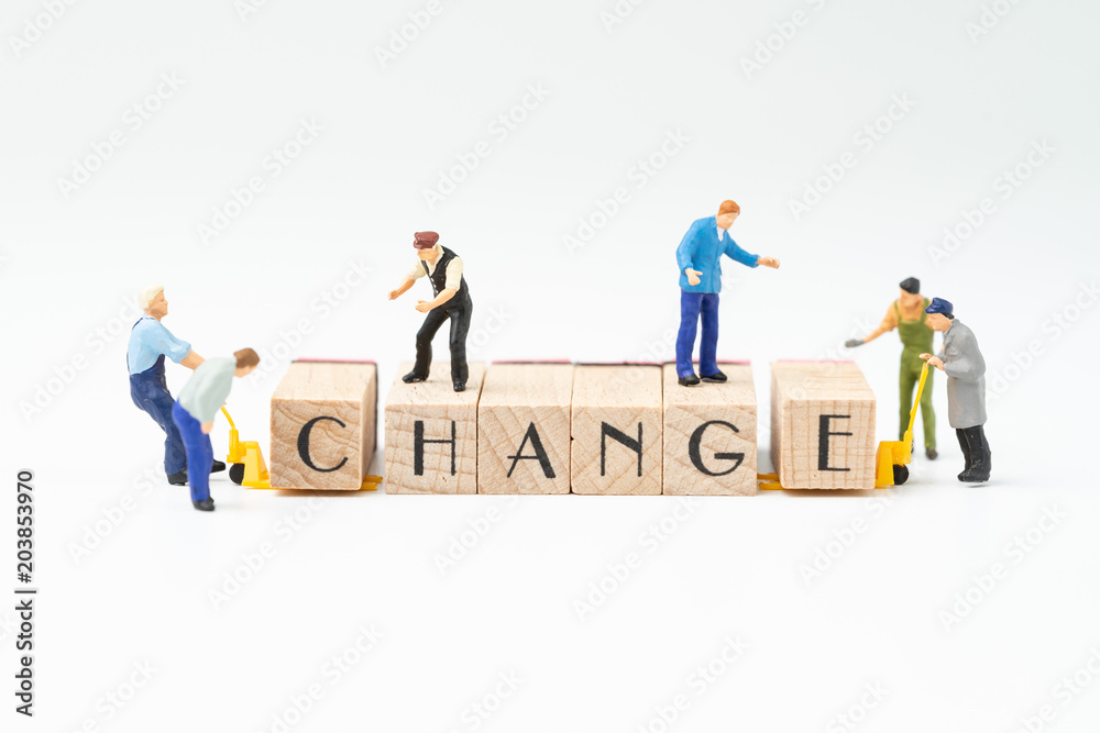Obraz premium Business change, transform or self development for success concept, miniature people figure, workers, employee staffs help move wooden stamp block to arrange the word CHANGE on white background