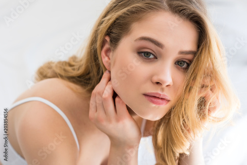 portrait of attractive young blonde woman looking at camera