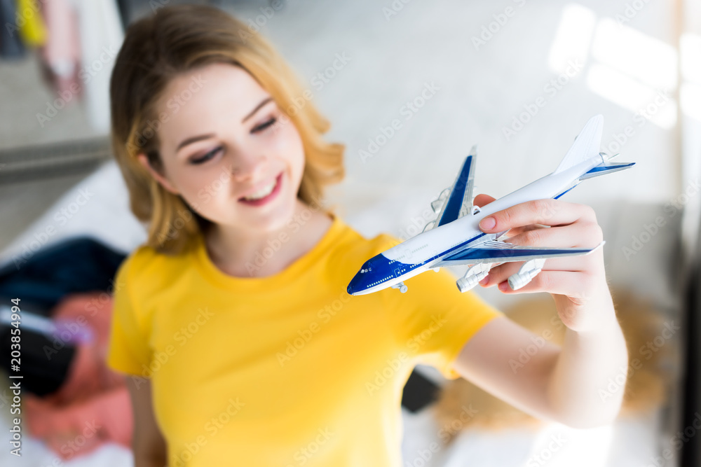 beautiful smiling young woman with airplane model beautiful smiling young woman with airplane model