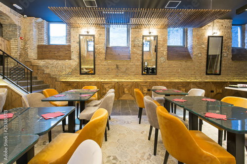 Interior of a modern hotel restaurant with brick wall