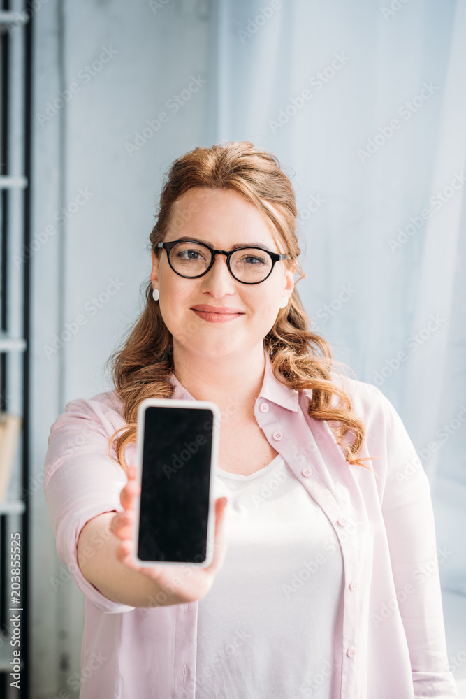 beautiful woman showing smartphone at home