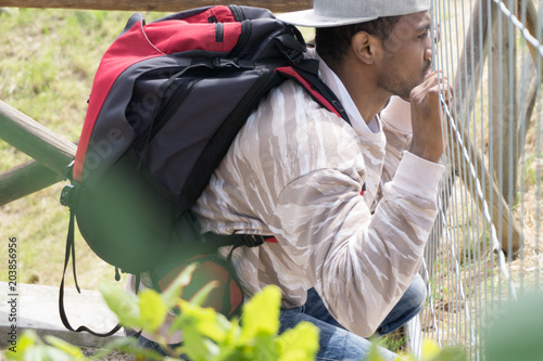 Картината върху платно young immigrant asylum seeker african refugee in front of barricade